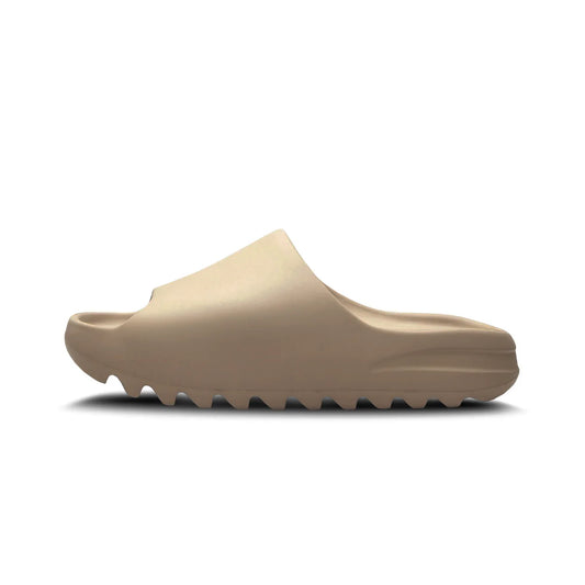 "Adidas Yeezy Slide 'Pure' in beige, one-piece slip-on design with cushioned footbed, midfoot arch support, and grooved outsole for grip and comfort."