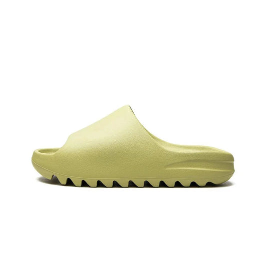 "Adidas Yeezy Slide 'Resin' in light green, one-piece slip-on design with soft footbed, midfoot arch support, and grooved outsole for durability and traction."